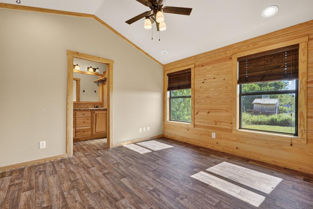 2401 Lamkin Road Mineral Wells, TX 76067 - Photo 16 of 36 a view of an empty room with a window and wooden floor