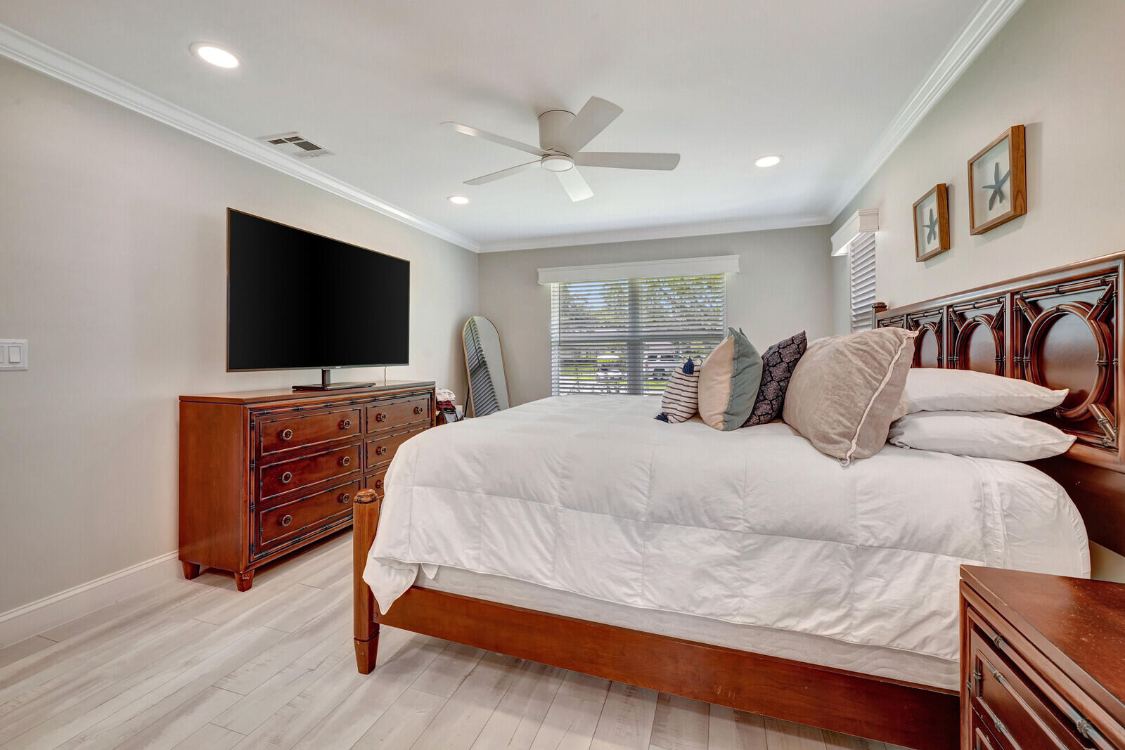6009 Eagles Nest Drive Jupiter, FL 33458 - Photo 16 of 49 a bedroom with a bed and a flat screen tv