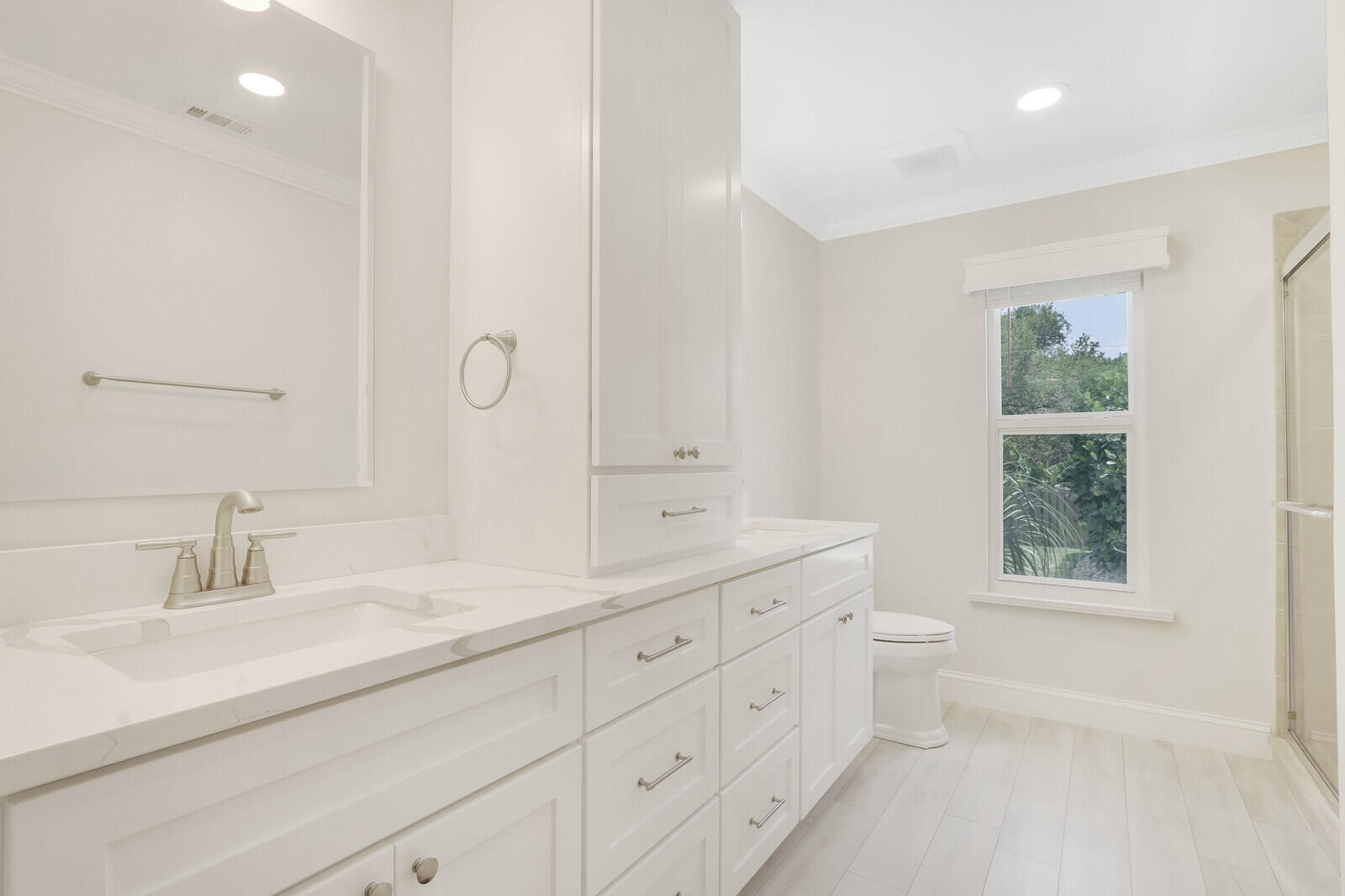 6009 Eagles Nest Drive Jupiter, FL 33458 - Photo 17 of 49 a bathroom with a double vanity sink a toilet and a window