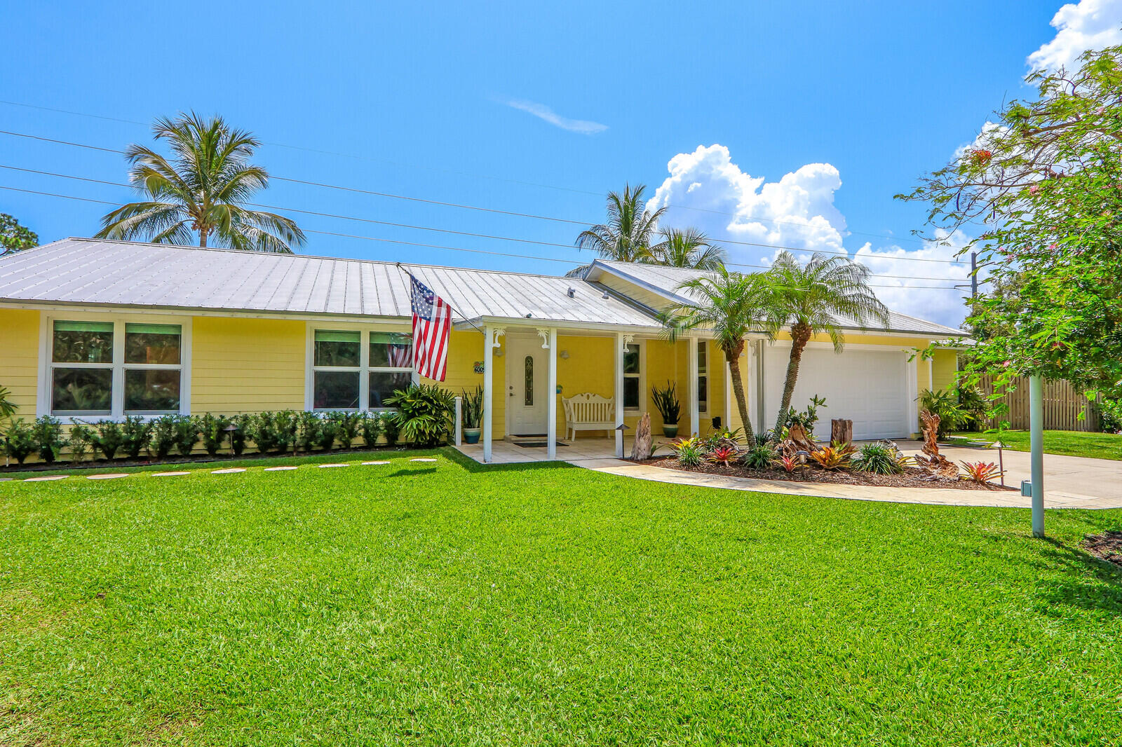 6009 Eagles Nest Drive Jupiter, FL 33458 - Photo 2 of 49 a view of a house with a yard and furniture