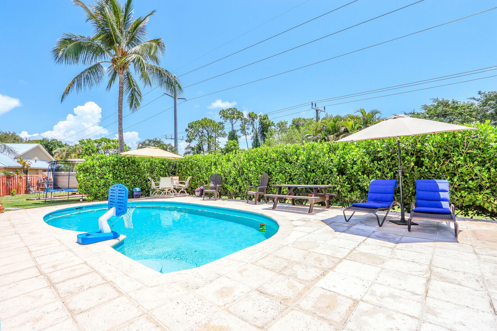 6009 Eagles Nest Drive Jupiter, FL 33458 - Photo 26 of 49 a view of a swimming pool with a patio