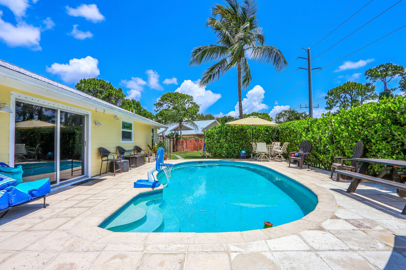 6009 Eagles Nest Drive Jupiter, FL 33458 - Photo 28 of 49 a swimming pool with outdoor seating and yard