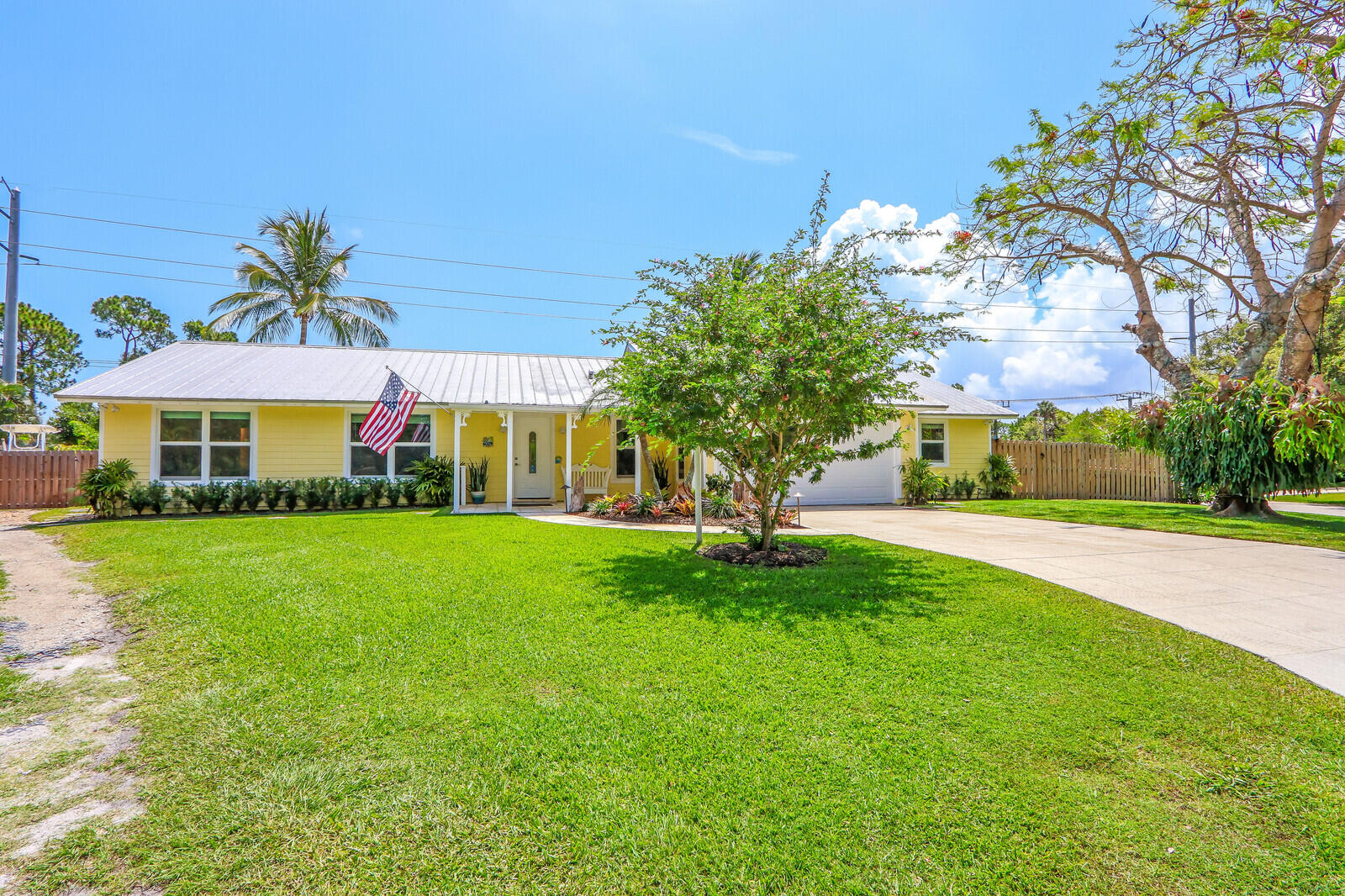 6009 Eagles Nest Drive Jupiter, FL 33458 - Photo 3 of 49 a front view of a house with a yard