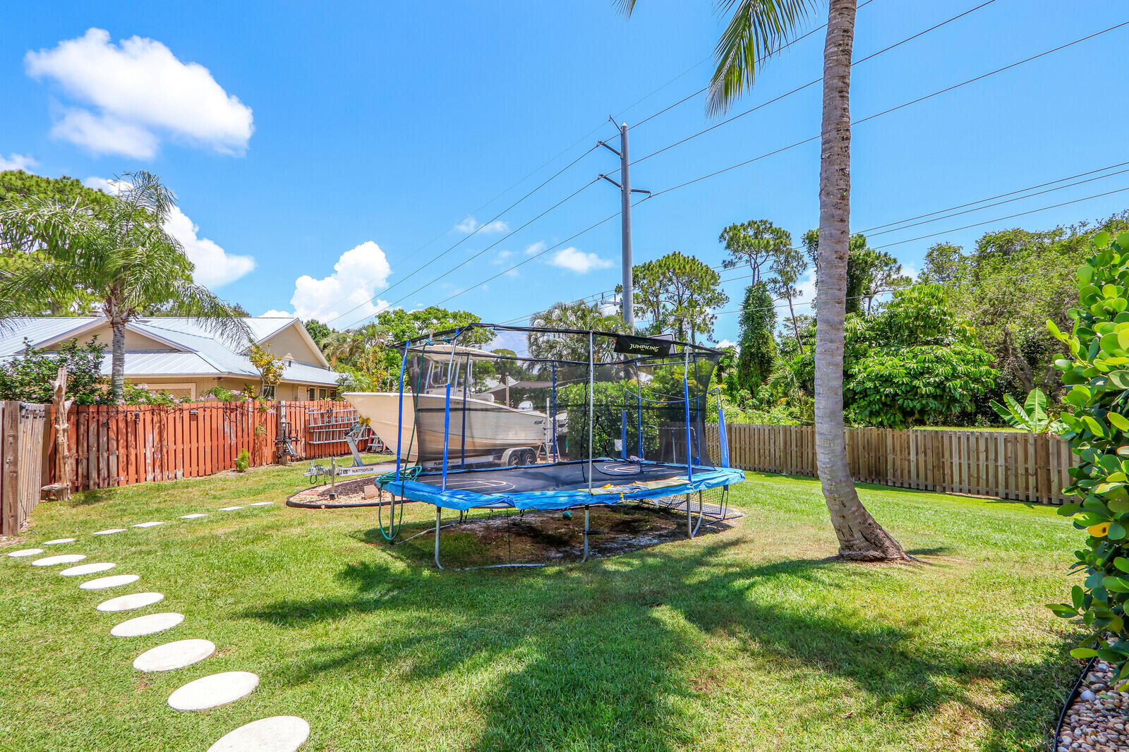 6009 Eagles Nest Drive Jupiter, FL 33458 - Photo 34 of 49 a view of a house with a backyard and a patio