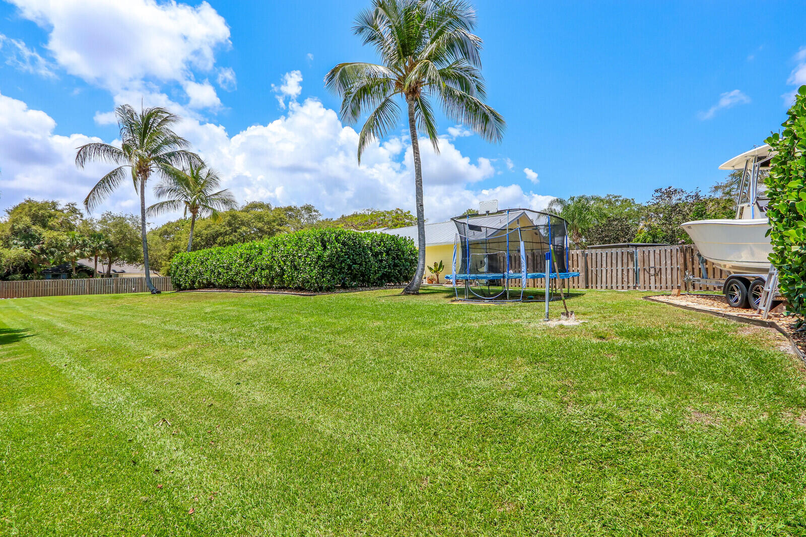 6009 Eagles Nest Drive Jupiter, FL 33458 - Photo 39 of 49 a view of a house with a big yard and palm trees