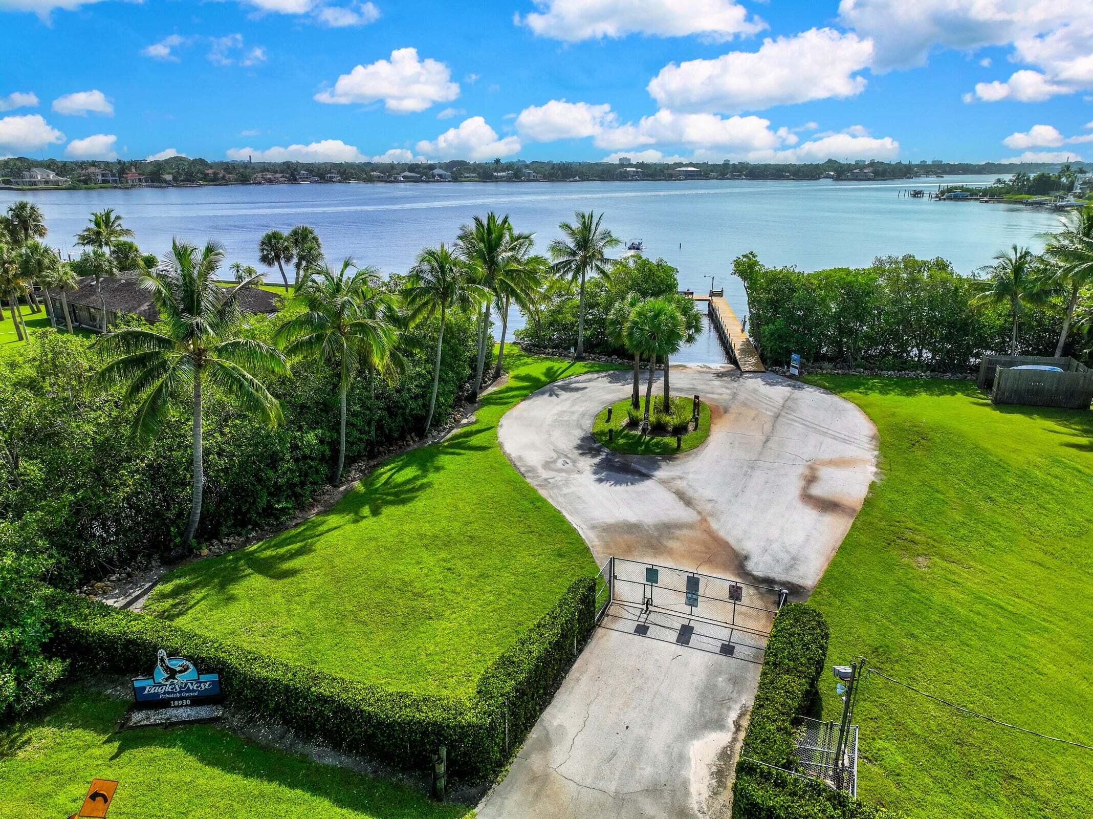 6009 Eagles Nest Drive Jupiter, FL 33458 - Photo 45 of 49 a view of a lake with a yard