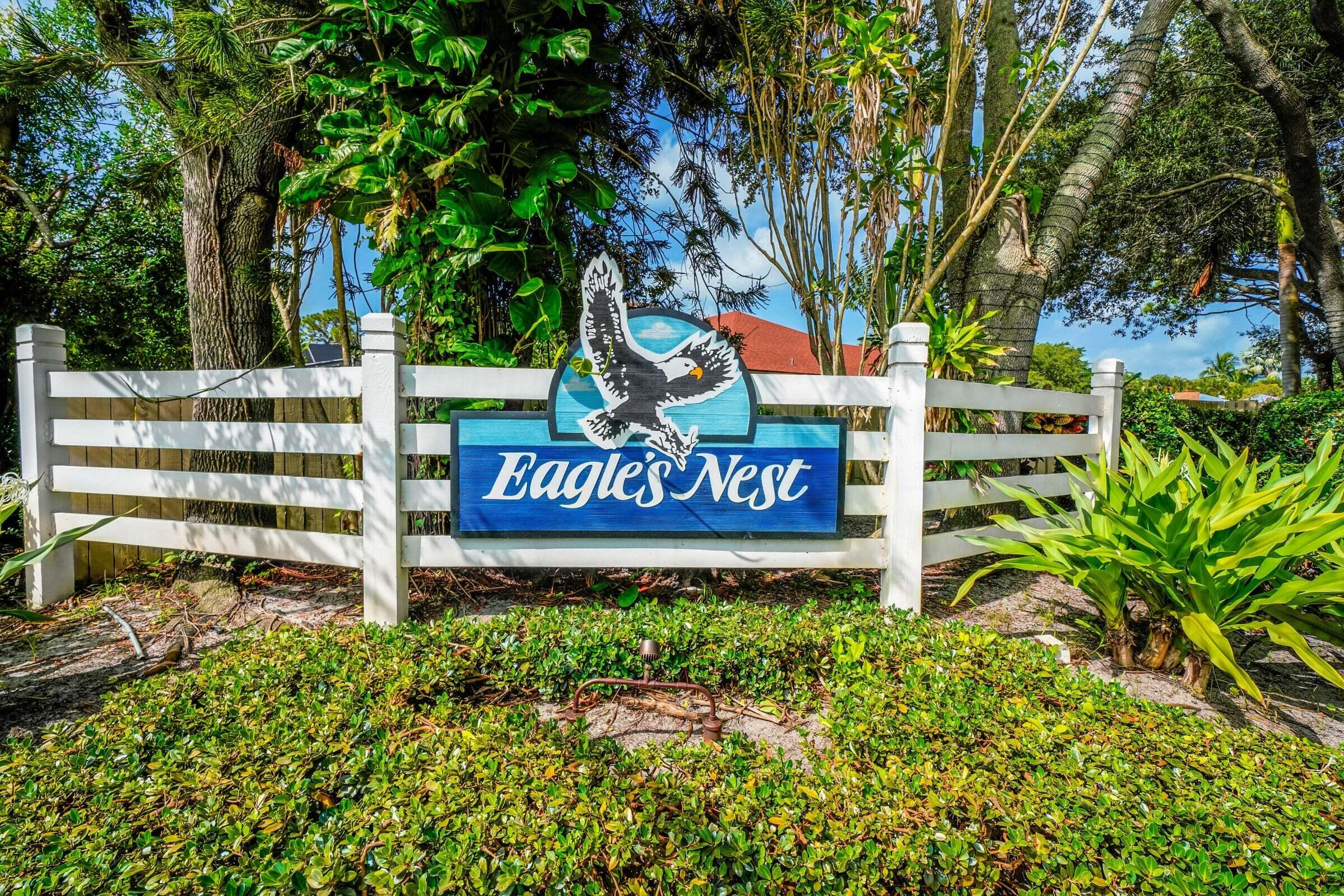 6009 Eagles Nest Drive Jupiter, FL 33458 - Photo 49 of 49 a sign that is sitting in front of a tree