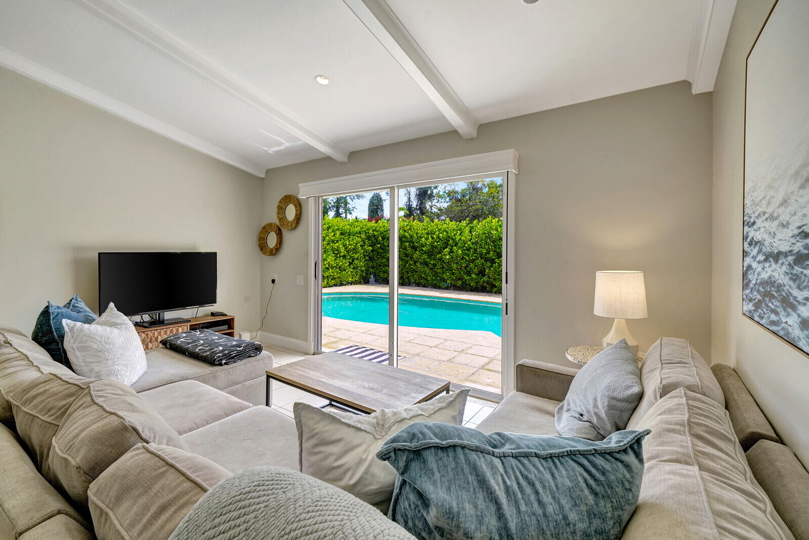 6009 Eagles Nest Drive Jupiter, FL 33458 - Photo 9 of 49 a living room with furniture a flat screen tv and a floor to ceiling window