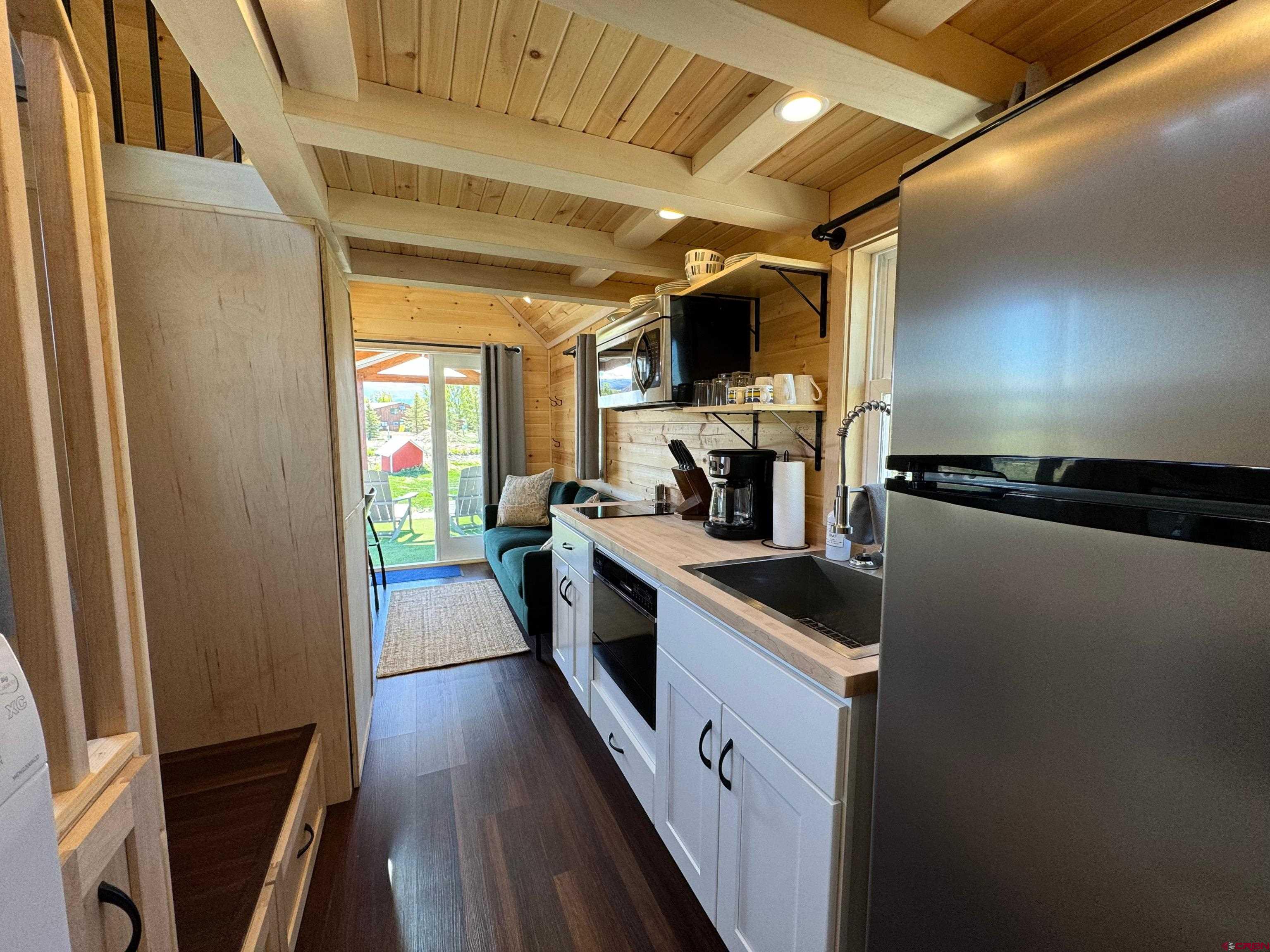 22130 6850 Road, Unit 210 Montrose, CO 81403 - Photo 14 of 35 a kitchen with stainless steel appliances a sink and wooden floor