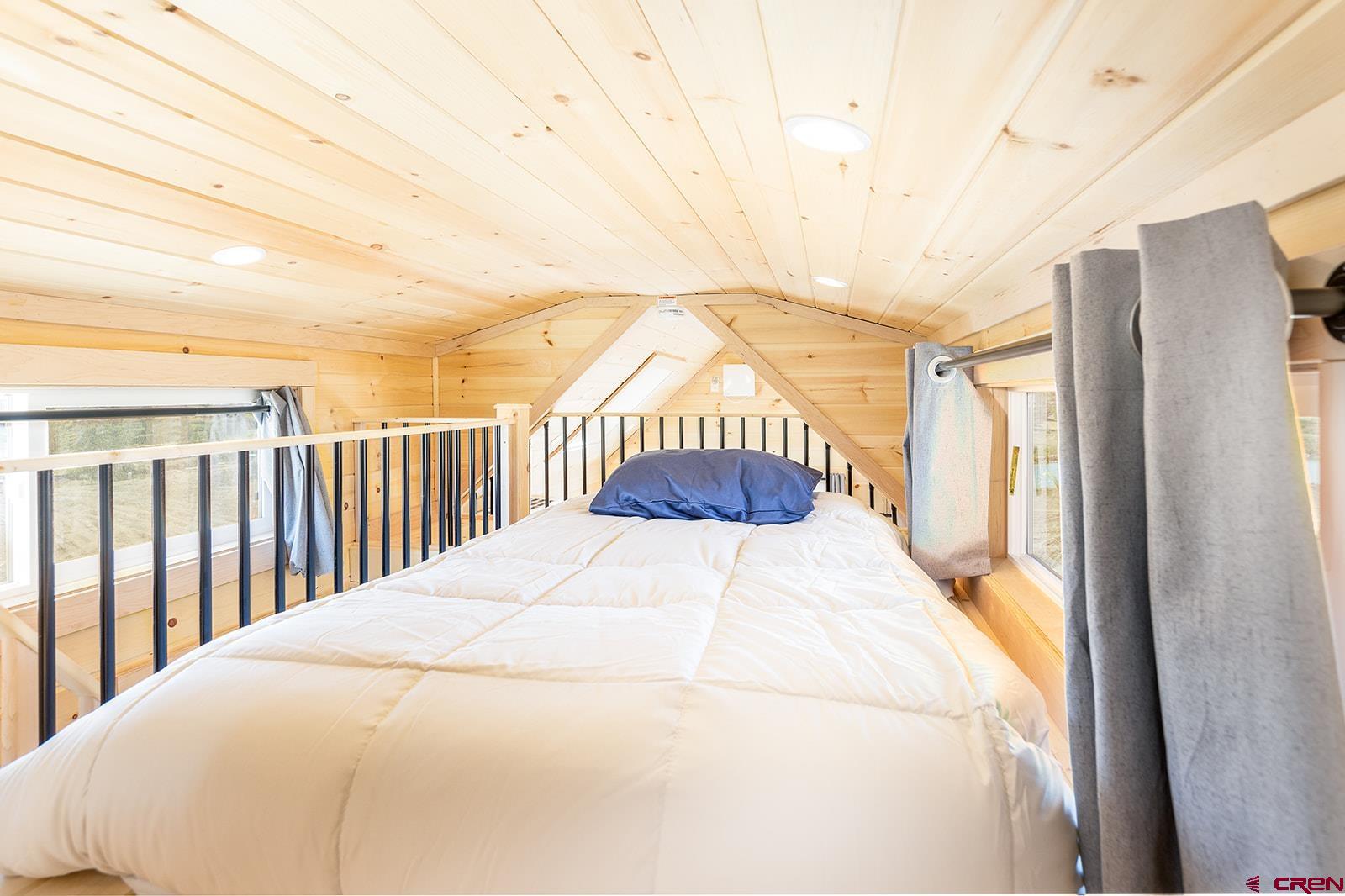 22130 6850 Road, Unit 210 Montrose, CO 81403 - Photo 18 of 35 a bedroom with a bed and a window