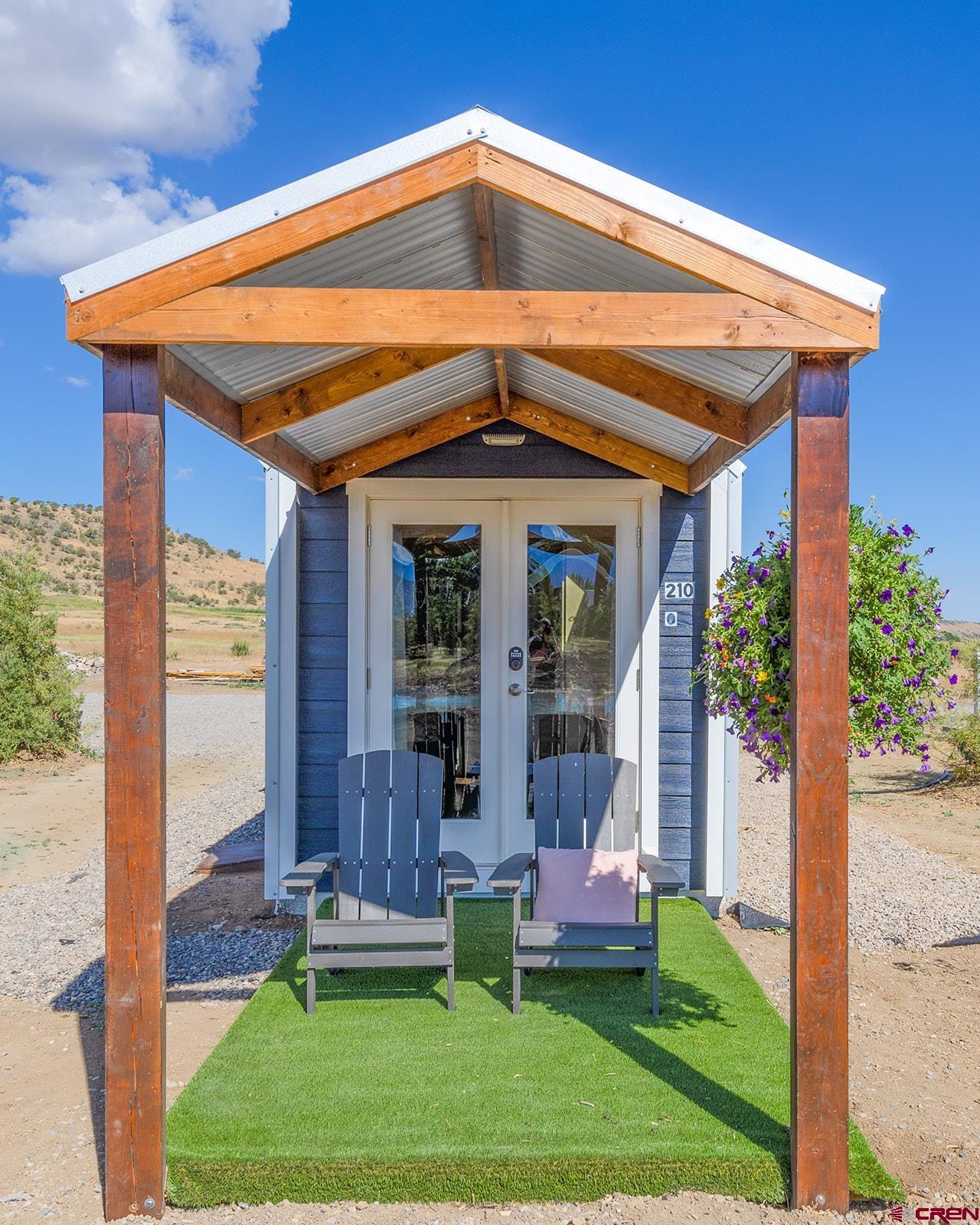 22130 6850 Road, Unit 210 Montrose, CO 81403 - Photo 22 of 35 a front view of house with a yard