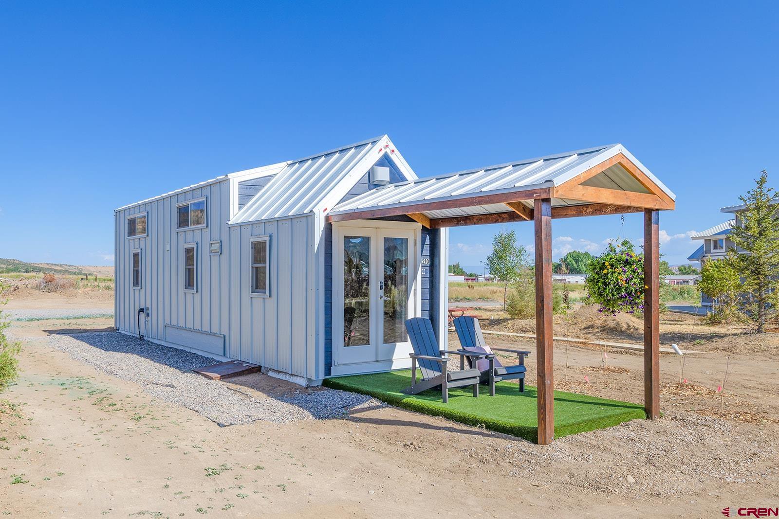 22130 6850 Road, Unit 210 Montrose, CO 81403 - Photo 23 of 35 a front view of a house with porch
