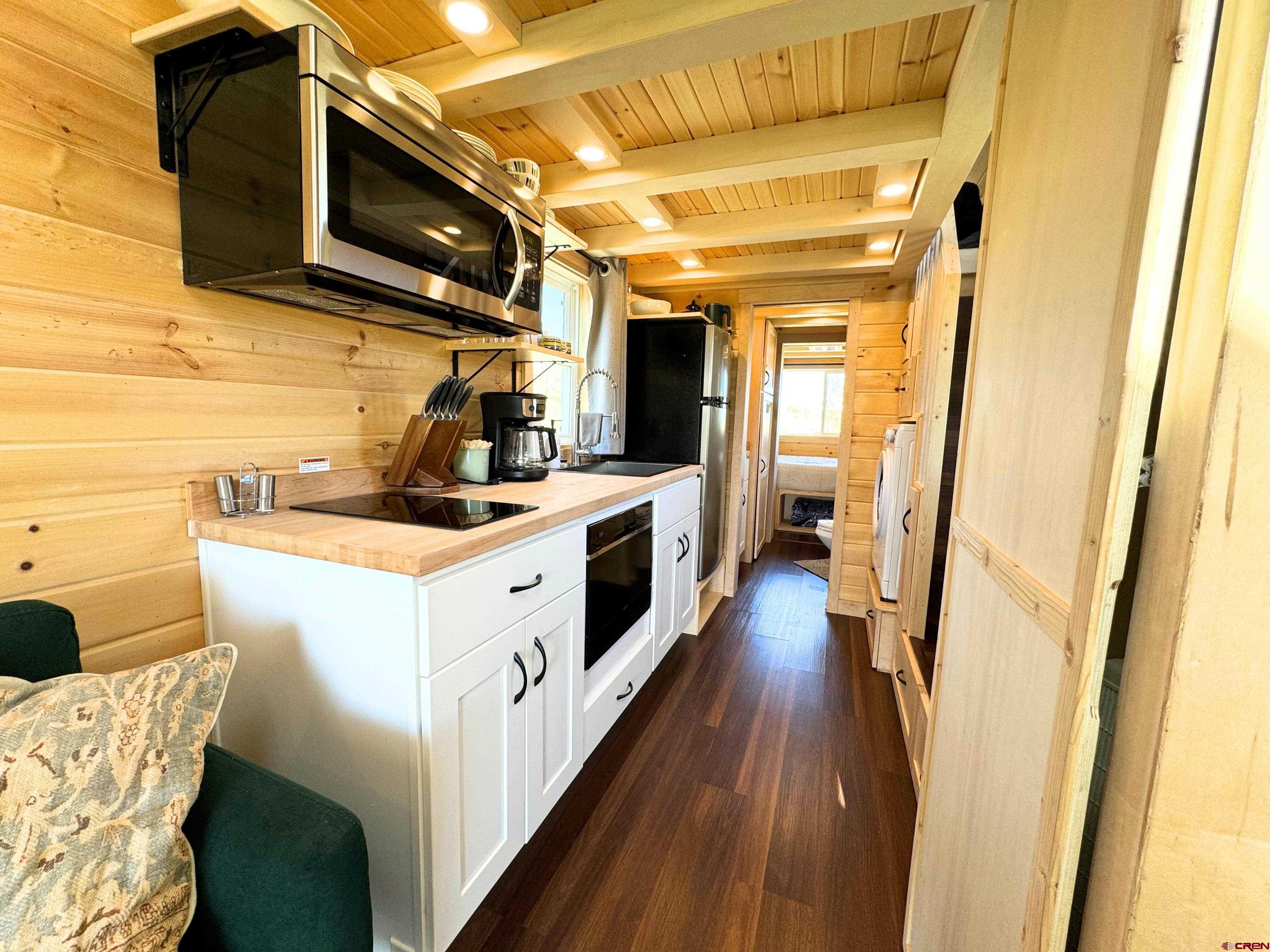 22130 6850 Road, Unit 210 Montrose, CO 81403 - Photo 5 of 35 a view of a kitchen with a sink a microwave and cabinets