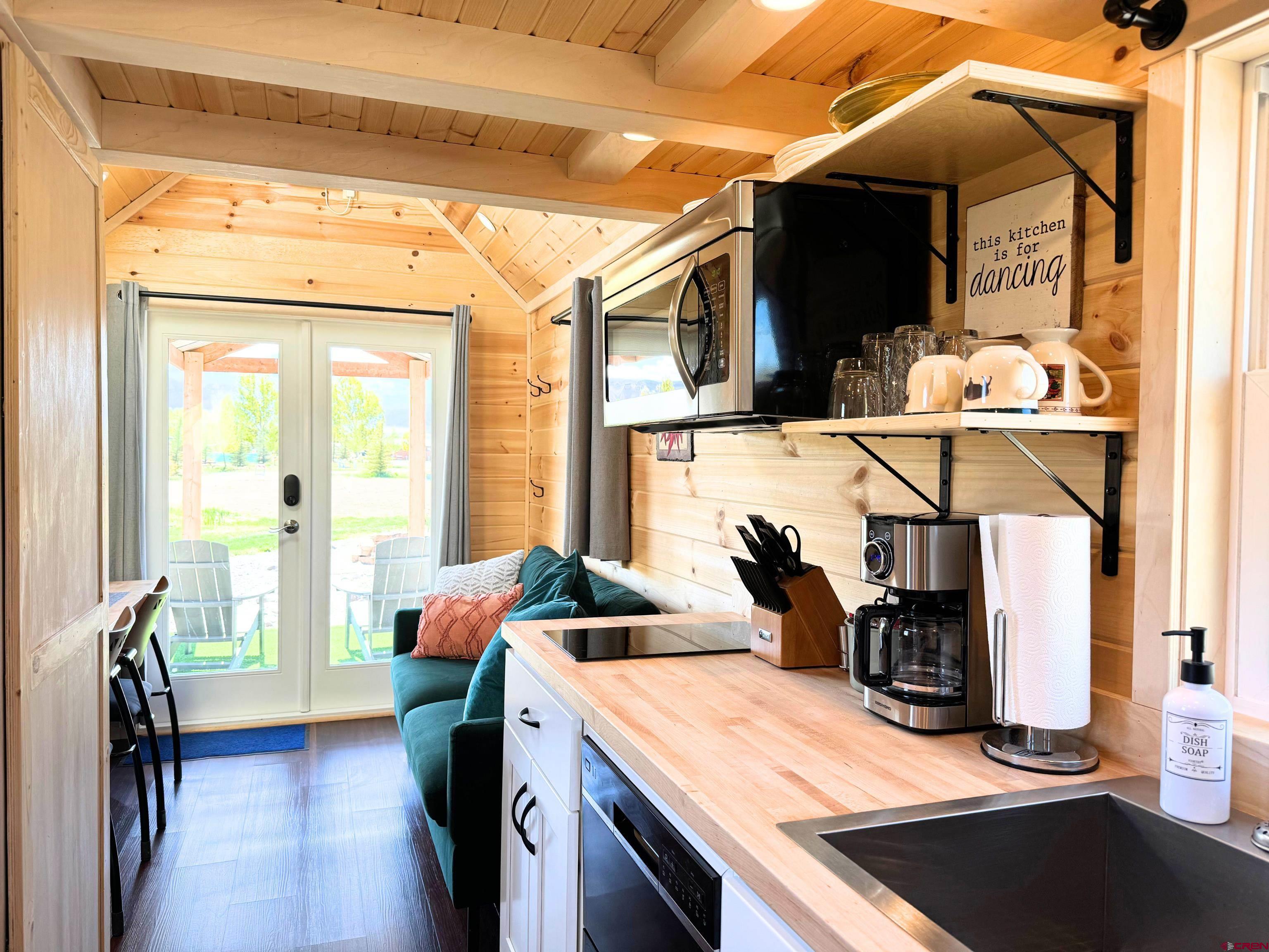 22130 6850 Road, Unit 210 Montrose, CO 81403 - Photo 6 of 35 a kitchen view of microwave a sink and a stove