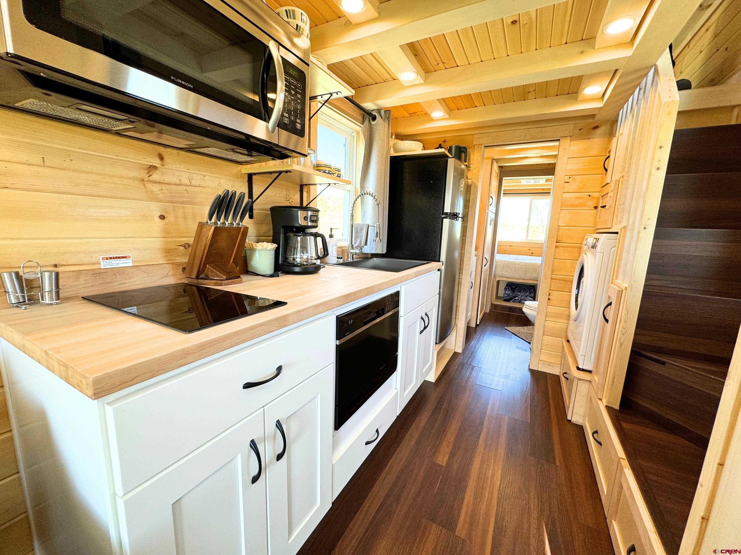 22130 6850 Road, Unit 210 Montrose, CO 81403 - Photo 7 of 35 a kitchen that has a sink and a wooden floor