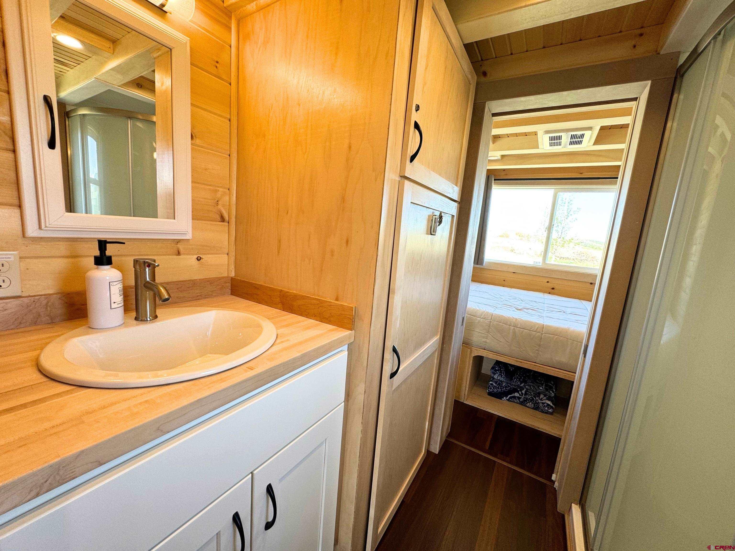 22130 6850 Road, Unit 210 Montrose, CO 81403 - Photo 8 of 35 a bathroom with a sink a toilet and a mirror