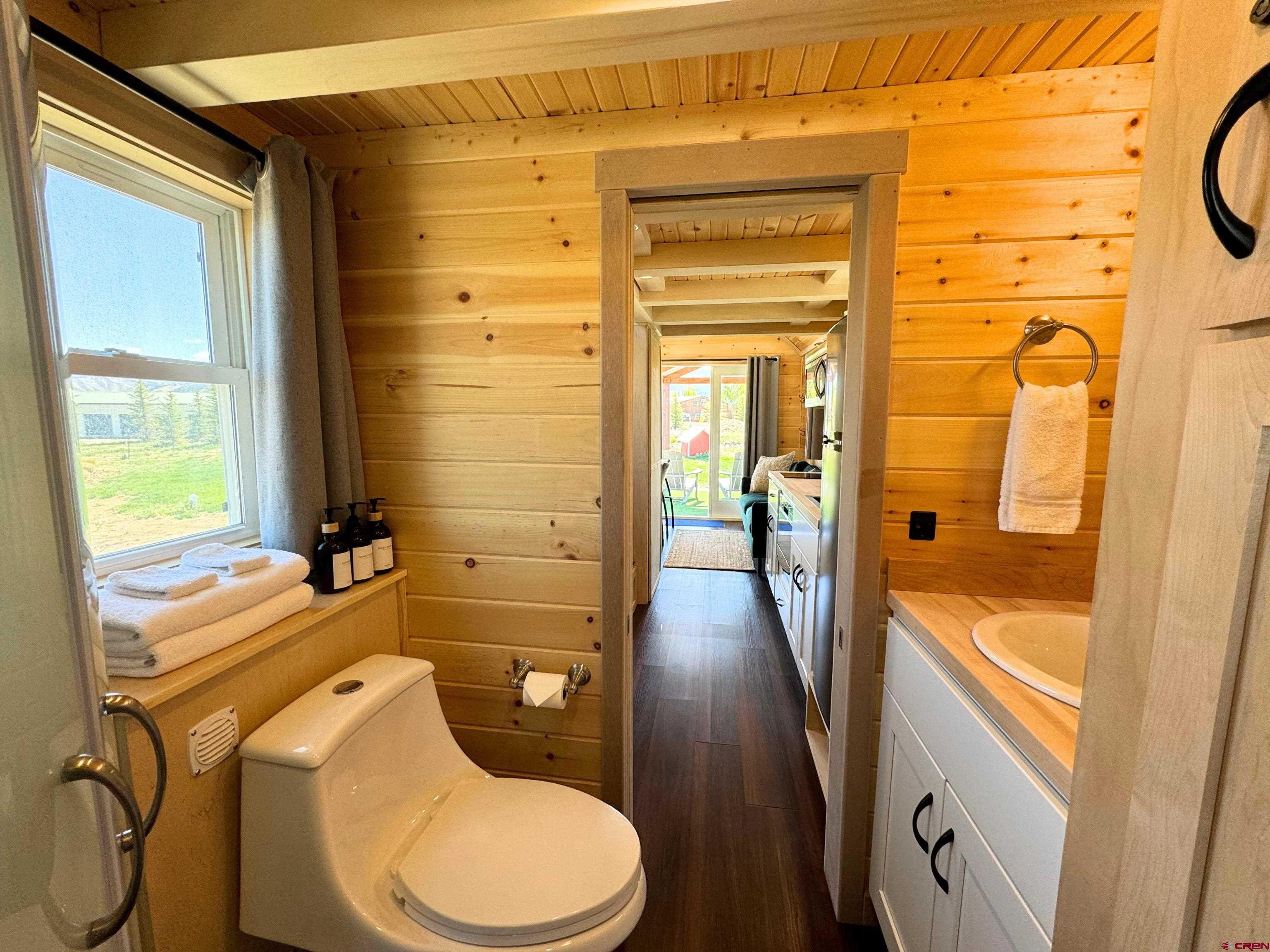 22130 6850 Road, Unit 210 Montrose, CO 81403 - Photo 9 of 35 a bathroom with a granite countertop toilet sink and mirror