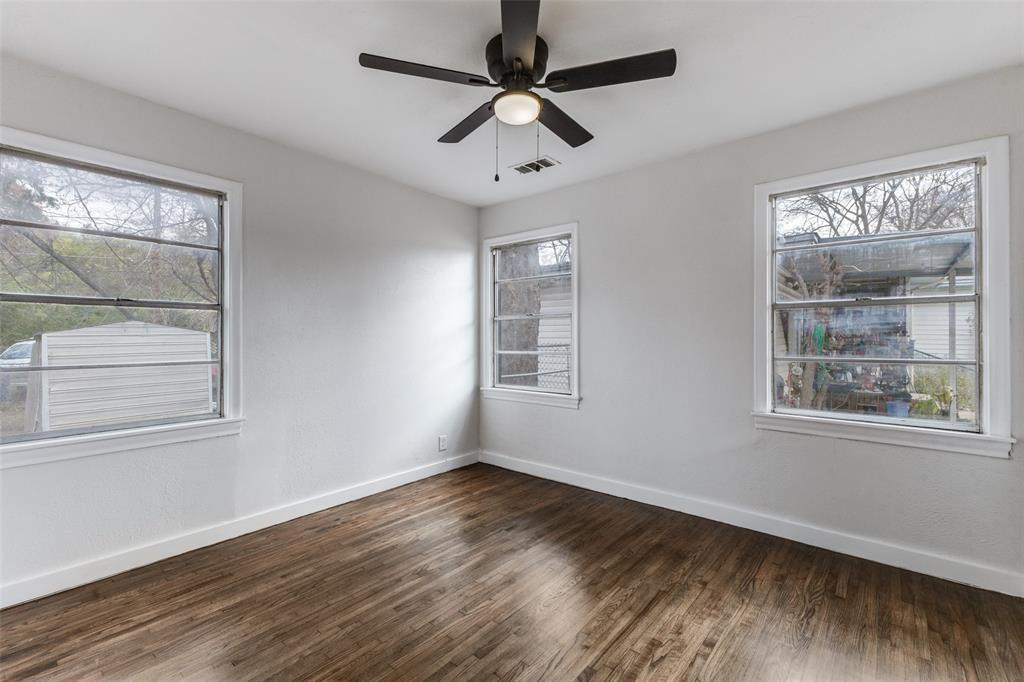 2723 Gus Thomasson Road Dallas, TX 75228 - Photo 19 of 26 a view of an empty room with wooden floor and a window