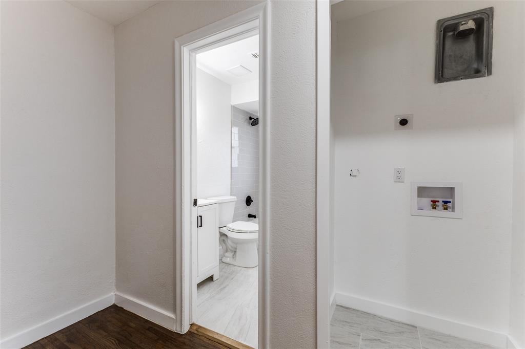 2723 Gus Thomasson Road Dallas, TX 75228 - Photo 21 of 26 a bathroom with a granite countertop toilet and a sink