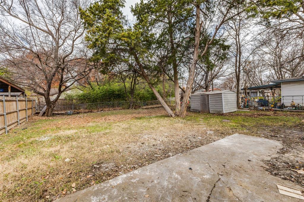 2723 Gus Thomasson Road Dallas, TX 75228 - Photo 23 of 26 a view of a house with a yard and garage