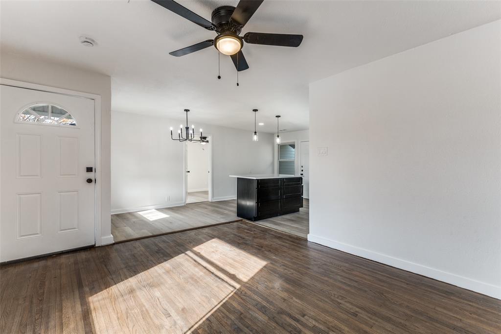 2723 Gus Thomasson Road Dallas, TX 75228 - Photo 4 of 26 a view of a big room with wooden floor and windows