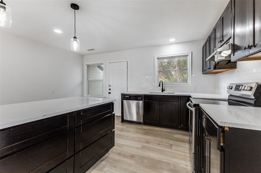 2723 Gus Thomasson Road Dallas, TX 75228 - Photo 10 of 26 a kitchen with a sink and stove
