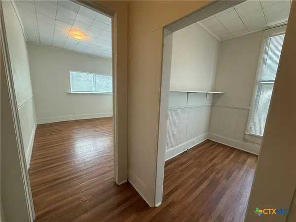 a view of a room with wooden floor