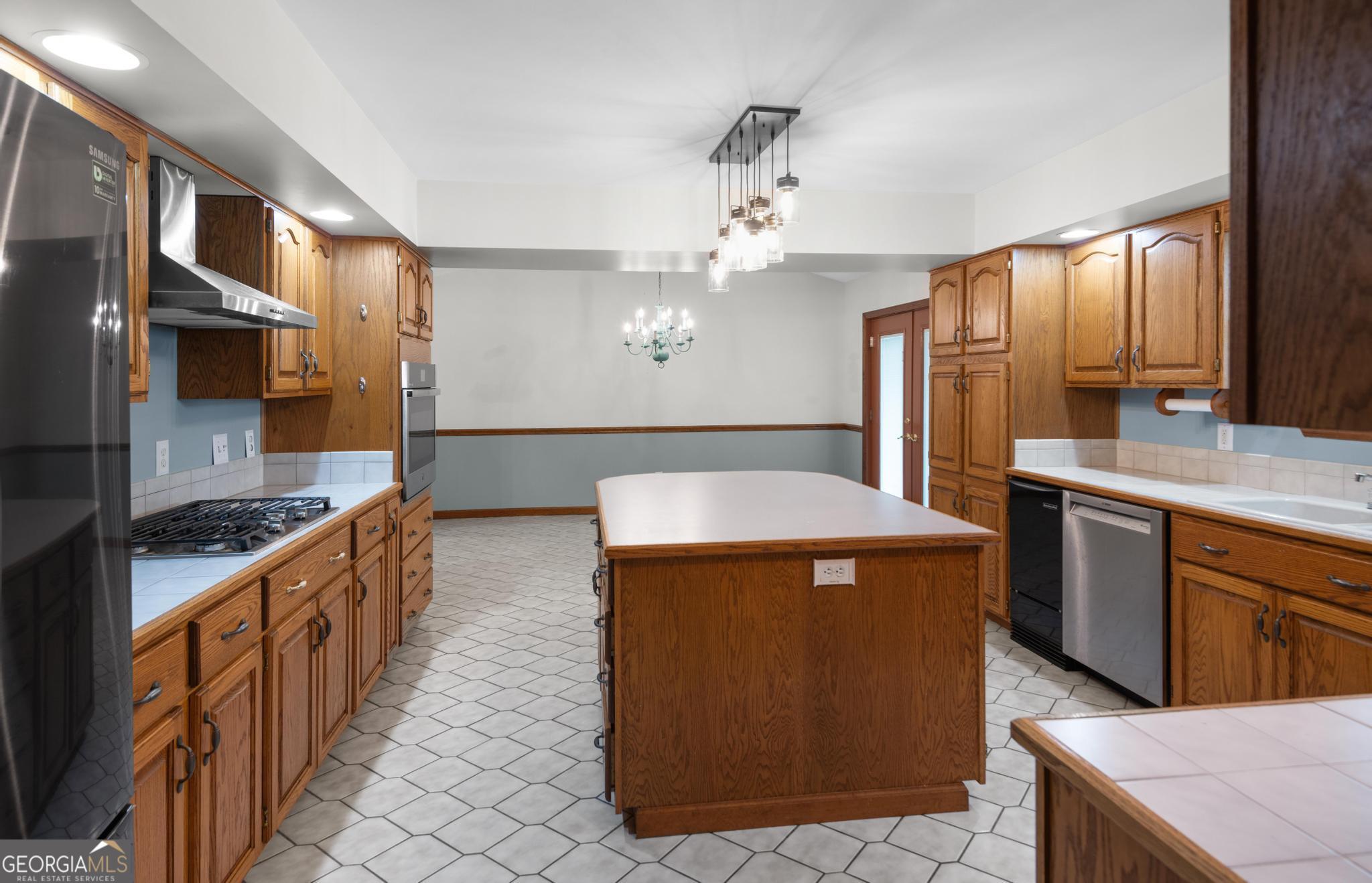 4909 Perry Road Claxton, GA 30417 - Photo 14 of 53 a kitchen with stainless steel appliances granite countertop a sink a stove and a refrigerator