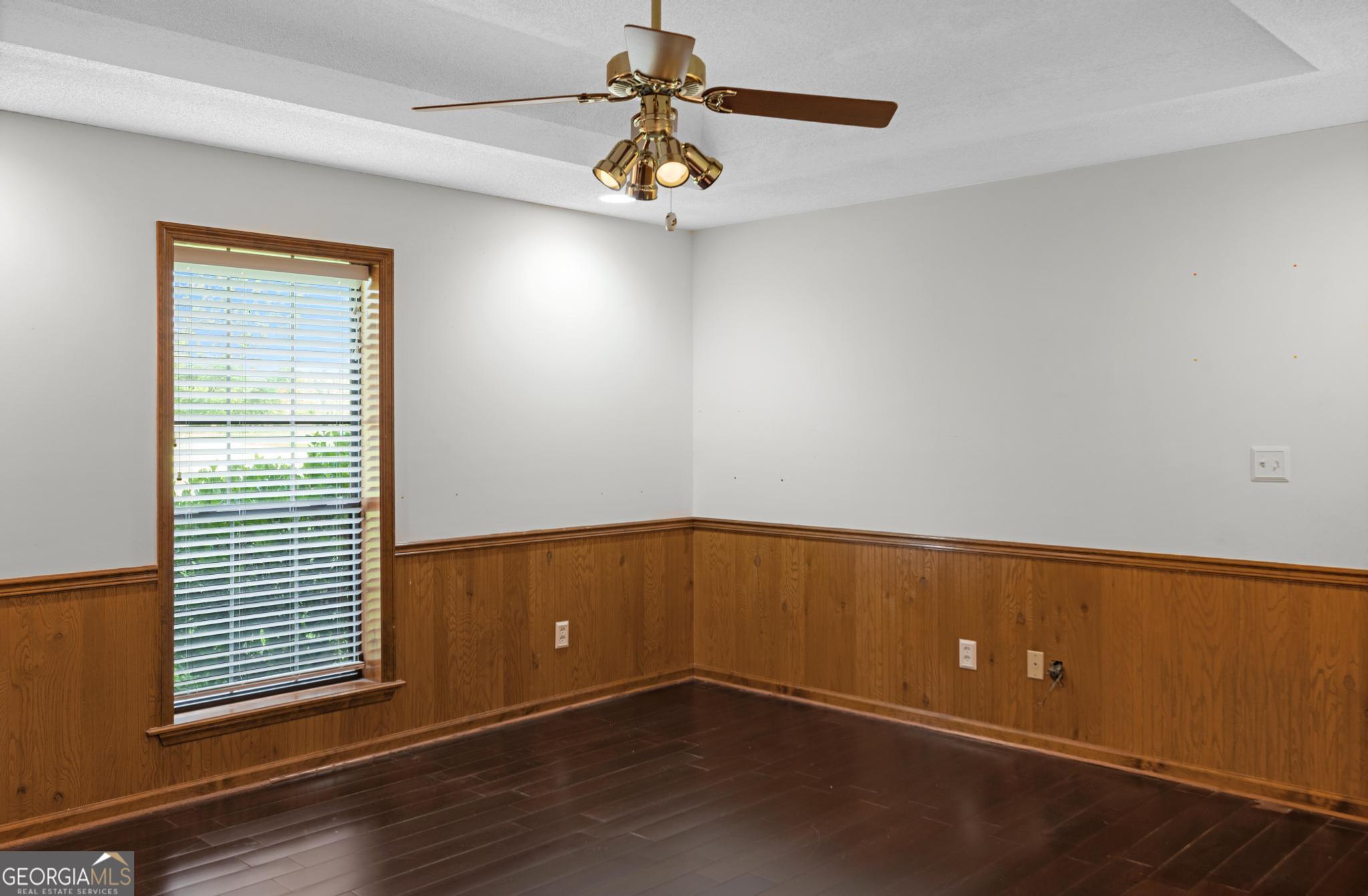 4909 Perry Road Claxton, GA 30417 - Photo 27 of 53 an empty room with wooden floor and windows