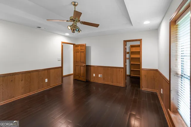 a view of walk in closet with empty racks