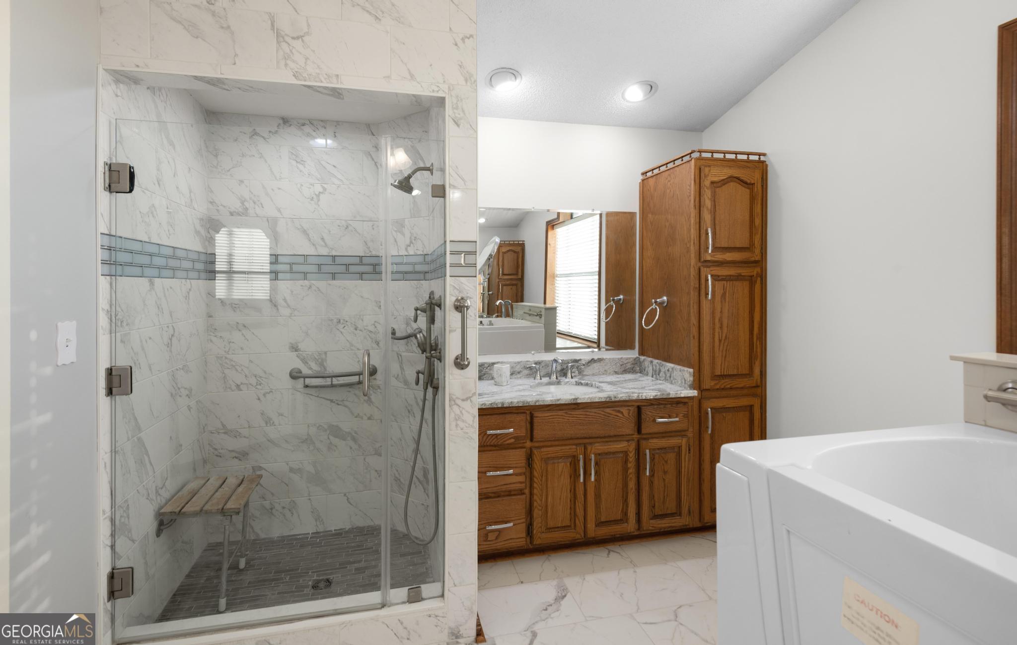 4909 Perry Road Claxton, GA 30417 - Photo 33 of 53 a bathroom with a granite countertop sink a toilet and shower