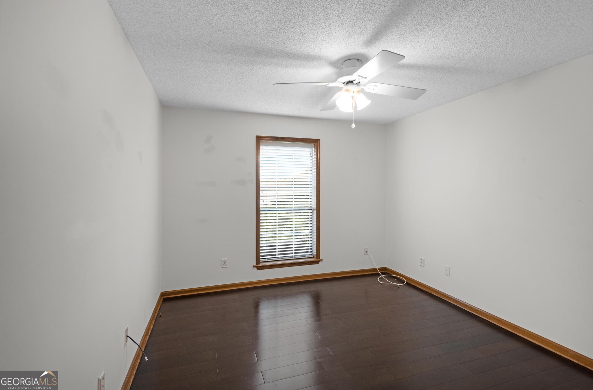 4909 Perry Road Claxton, GA 30417 - Photo 40 of 53 an empty room with a window and ceiling fan