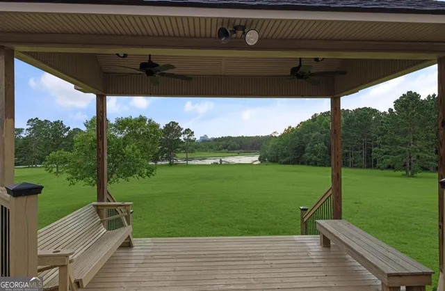a aerial view of a house next to a yard and large trees
