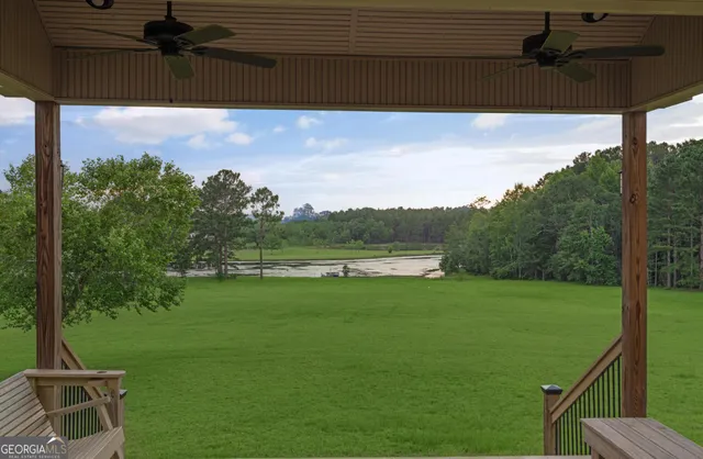 a view of a house with a yard and a porch