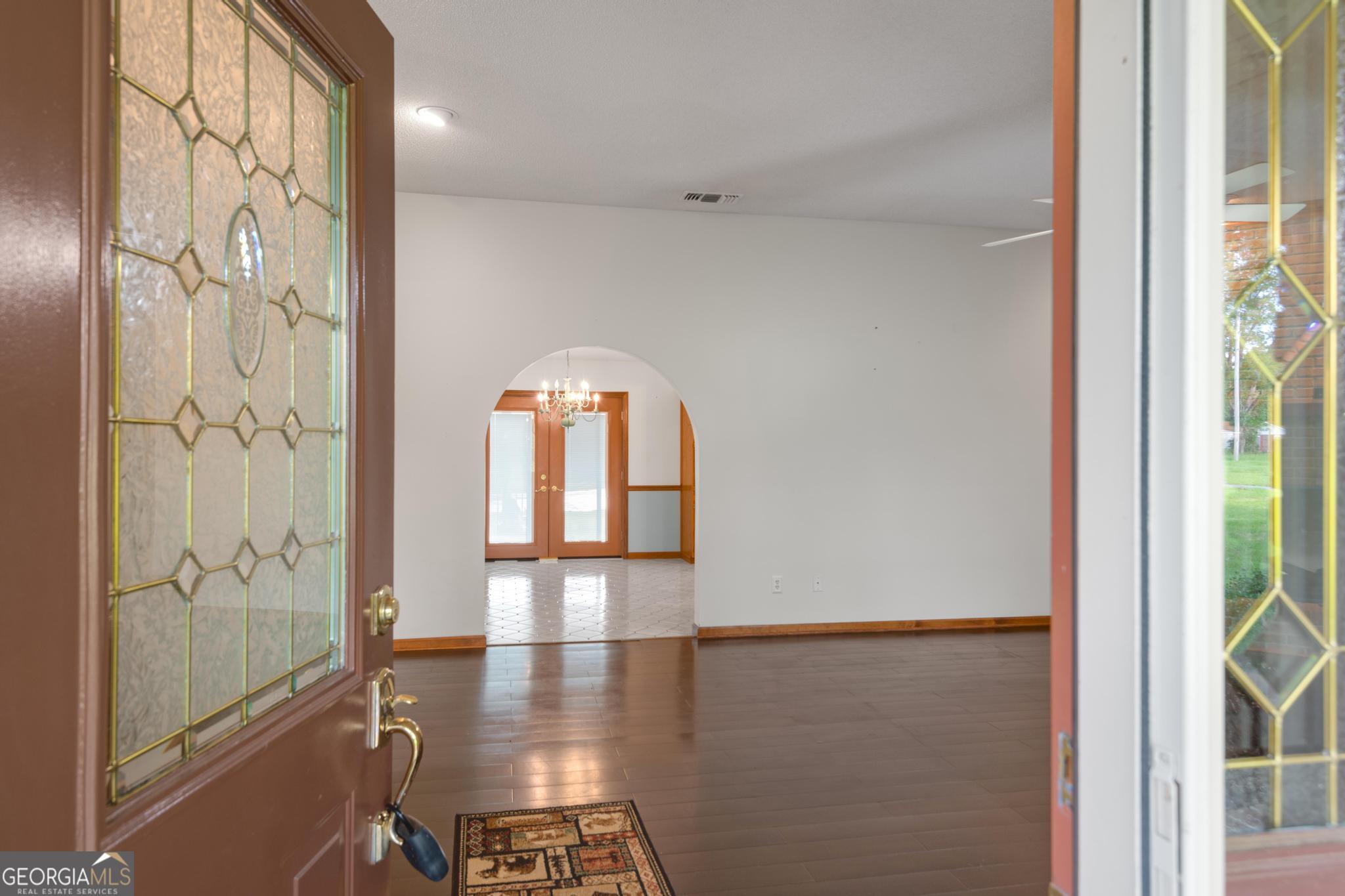 4909 Perry Road Claxton, GA 30417 - Photo 5 of 53 a view of a hallway with wooden floor and a dining room