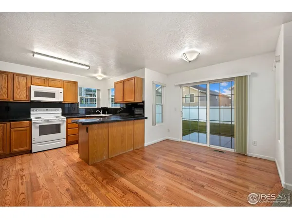 a kitchen with stainless steel appliances kitchen island granite countertop a stove top oven and sink