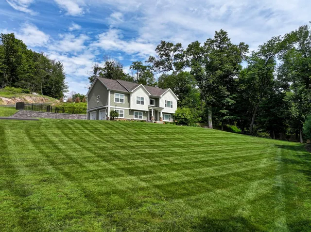 a front view of a house with a yard