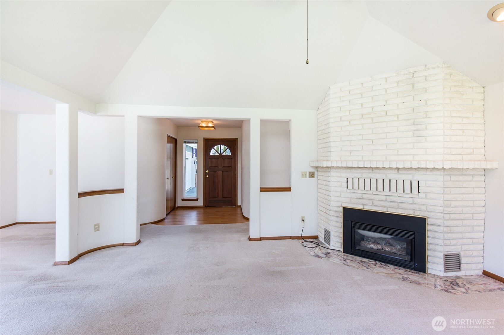170 Hurricane Ridge Drive Sequim, WA 98382 - Photo 17 of 39 an entryway and an empty room with a fireplace