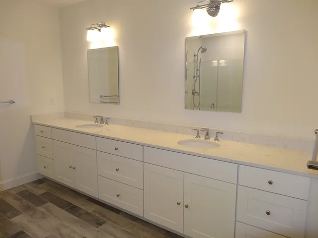a bathroom with double sink and a mirror