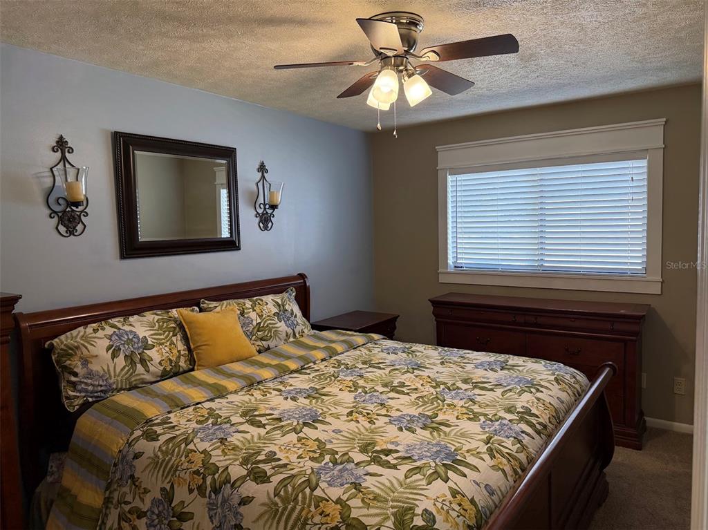 3021 Southeast 5th Terrace, Unit A Ocala, FL 34471 - Photo 11 of 13 a bed sitting in a bedroom next to a window