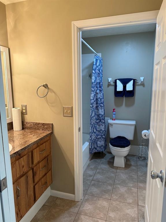 3021 Southeast 5th Terrace, Unit A Ocala, FL 34471 - Photo 12 of 13 a bathroom with a sink a toilet and a mirror
