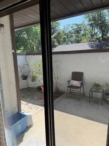 a view of living room with furniture and a floor to ceiling window