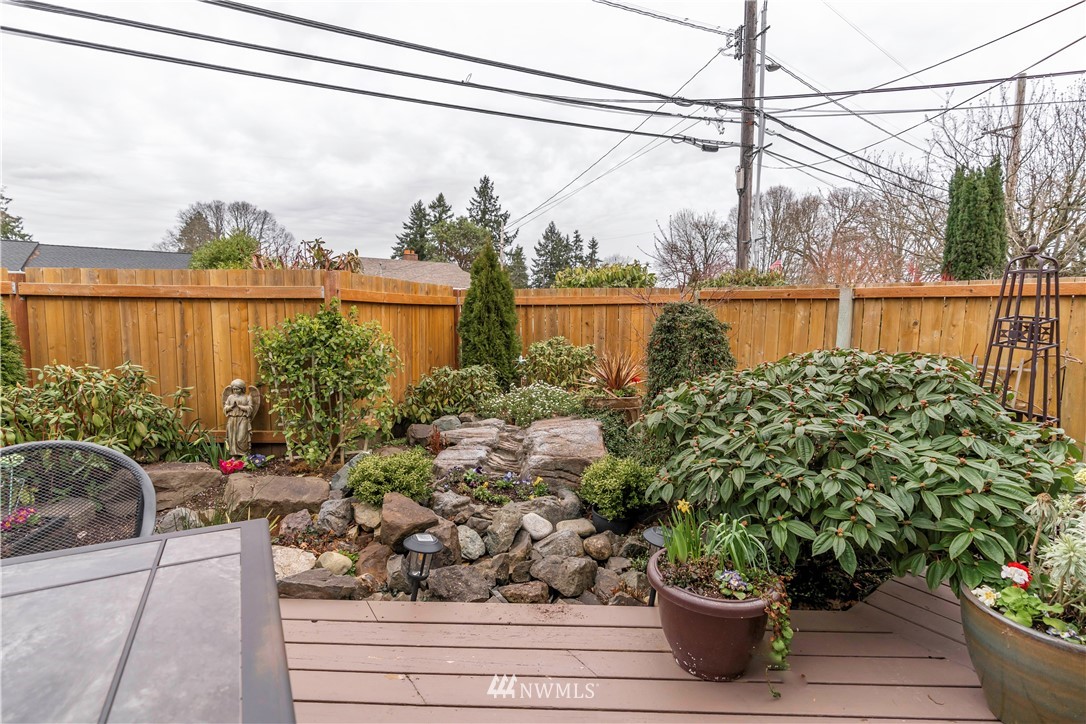 6502 Avondale Road Southwest, Unit 4 Lakewood, WA 98499 - Photo 20 of 28 a view of a potted flower in a yard next to a yard