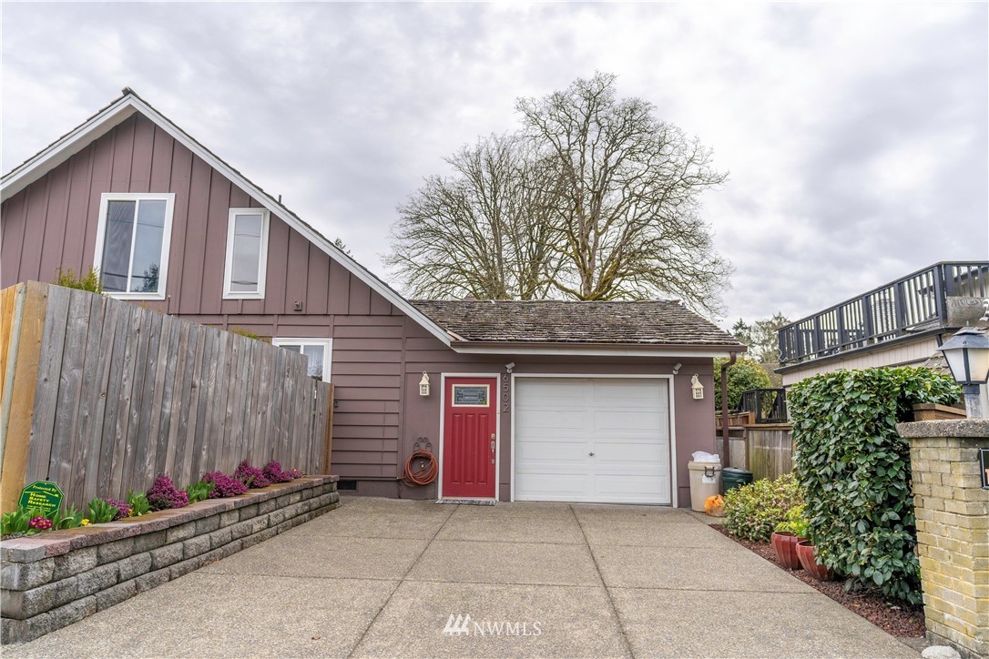 6502 Avondale Road Southwest, Unit 4 Lakewood, WA 98499 - Photo 28 of 28 a front view of a house with a garage