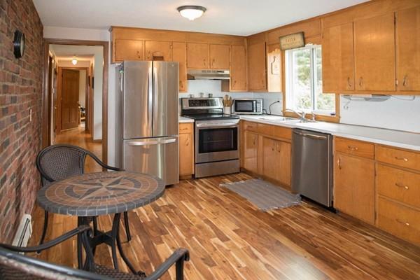 25 Fairview Road Wilbraham, MA 01095 - Photo 6 of 32 a kitchen with stainless steel appliances granite countertop a stove a refrigerator and a microwave