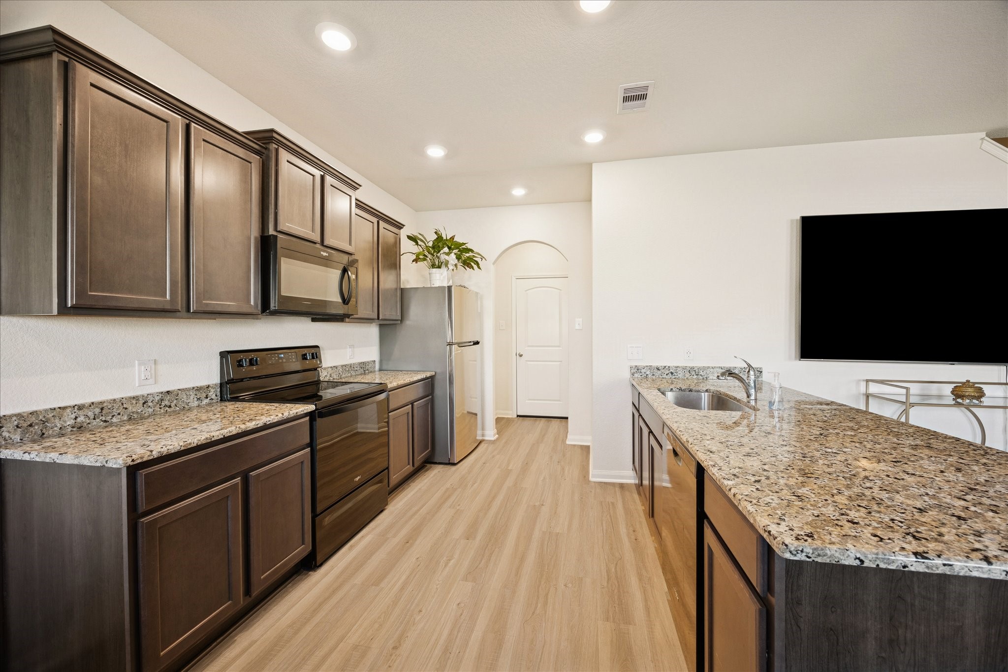 6215 El Turquesa Drive Houston, TX 77048 - Photo 6 of 16 a kitchen with stainless steel appliances granite countertop a stove and a sink