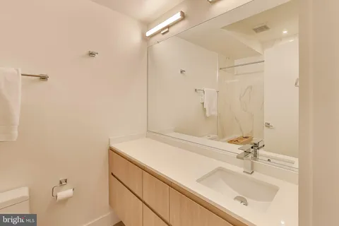 a bathroom with a sink vanity and a mirror