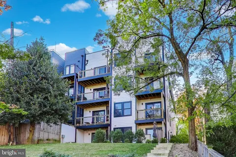 a house that has a tree in front of it