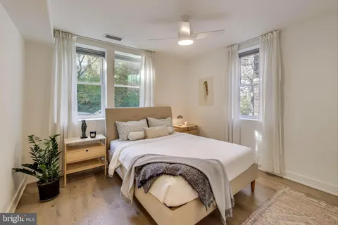 a bedroom with a bed and a potted plant