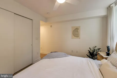 a bedroom with a bed and a potted plant